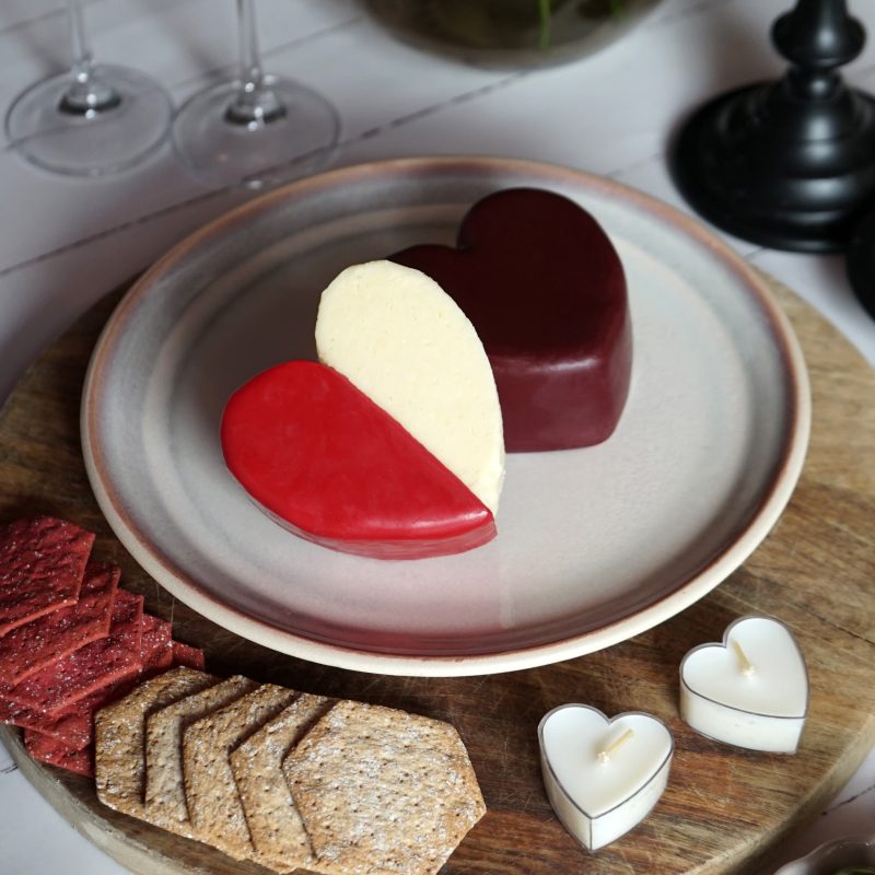 Barber's Cheese wax truckle heart on plate in romantic setting 